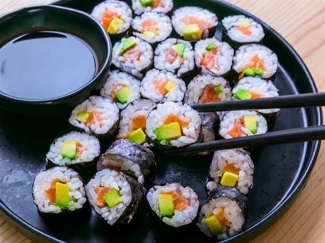 Colorful sushi rolls served with soy sauce
